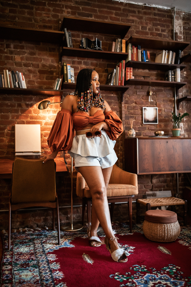 Woman with Beads and Braids Wearing Fe Noel Rust Puff Sleeve Bodysuit